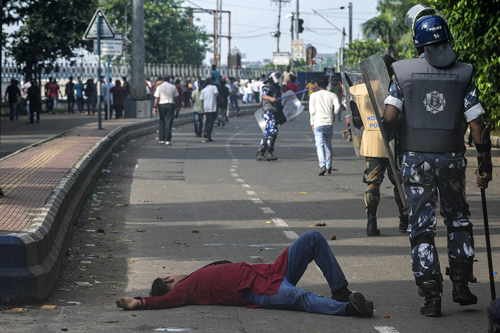 Kolkata Rape-Murder Case: A protester lies on the road after police beat him during the protest